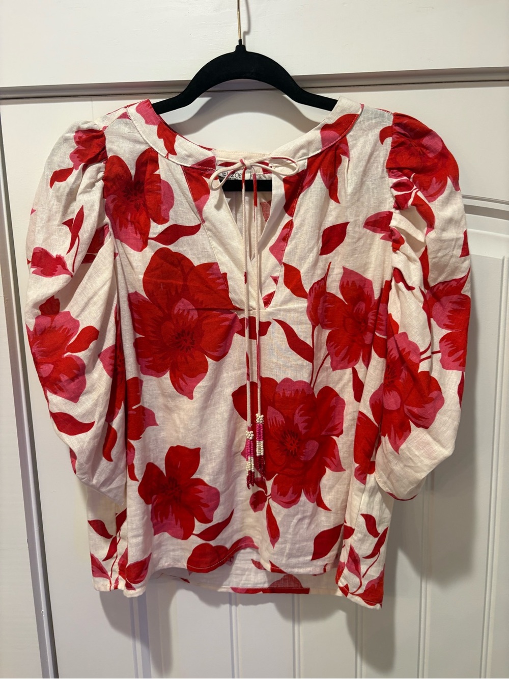 Rachel Zoe White Blouse with Bold Red Floral Print and Tie Neck with beads.
